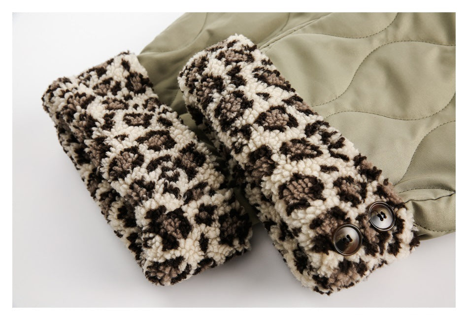 Close-up of olive-khaki quilted trousers with cream and dark patterned fleece cuffs and buttons.