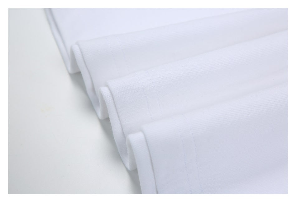 Close-up of folded white garment hems with visible stitching.