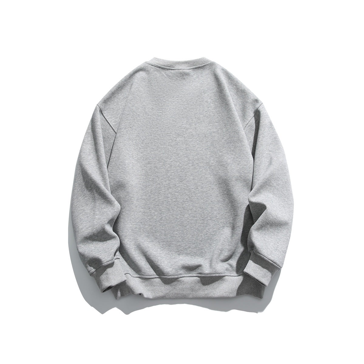 Back view of a plain heather gray crewneck sweatshirt with long sleeves and ribbed cuffs and hem.