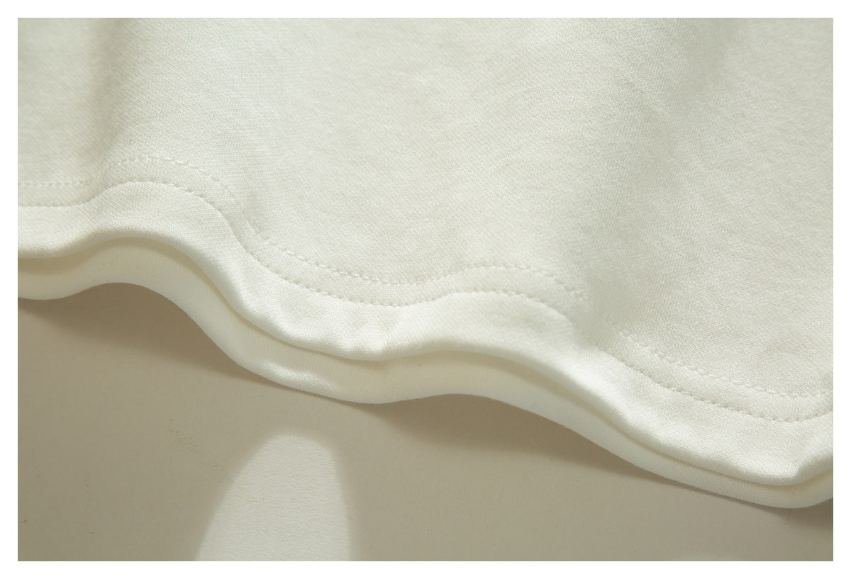 Close-up of the white T-shirt's stitched bottom hem.