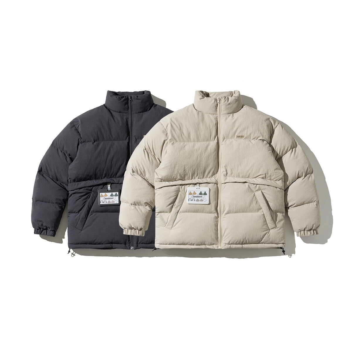 Front view of padded zip jackets in charcoal and light beige, with high collars and angled pockets.