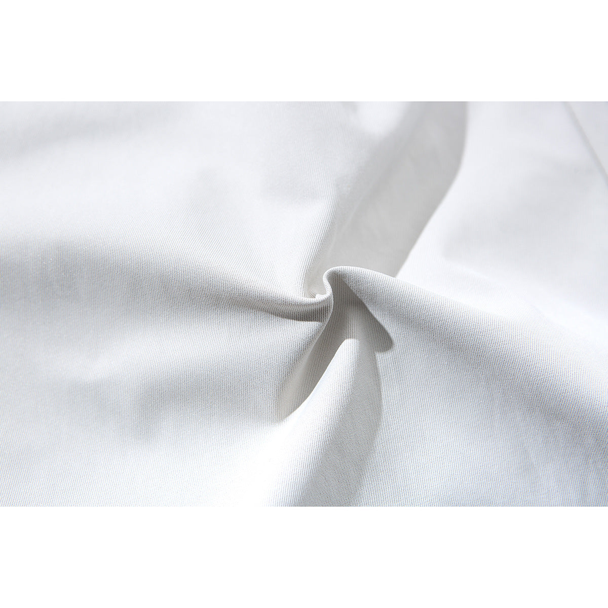 Close-up of the white shorts fabric, showing its fine surface texture and drape.