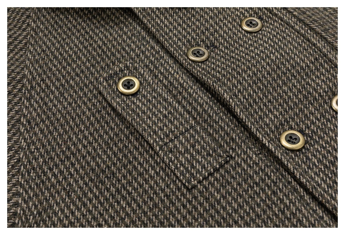 Close-up of the jacket's houndstooth fabric, stitched pocket flap, and brass-tone buttons.