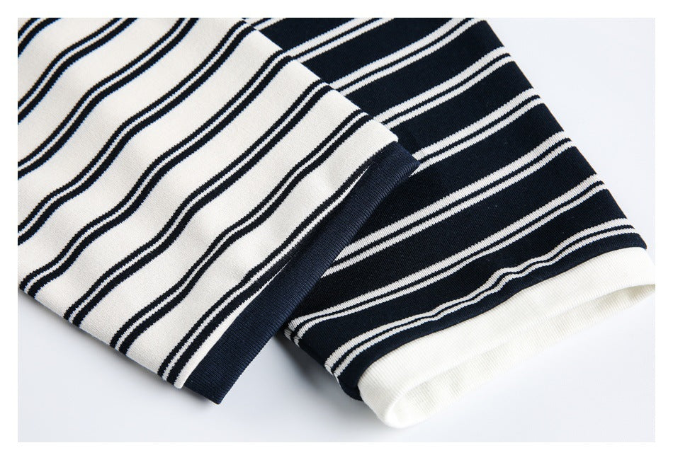 Close-up of striped sleeve cuffs with contrasting navy and white ribbed trim.