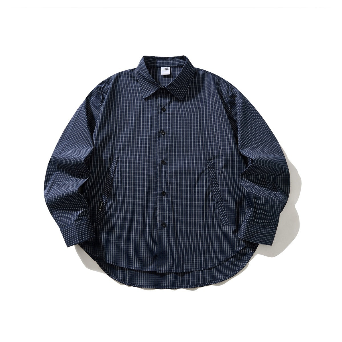 Navy long-sleeve button-up shirt with a fine light grid check, pointed collar and curved hem, laid flat