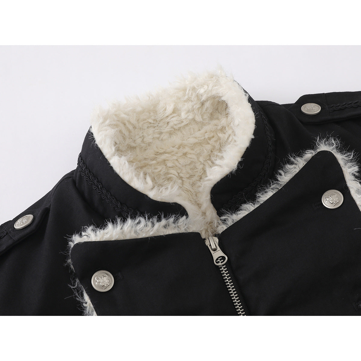 Close-up of a black jacket with a white fluffy collar lining, front zipper, braided trim, and silver buttons.
