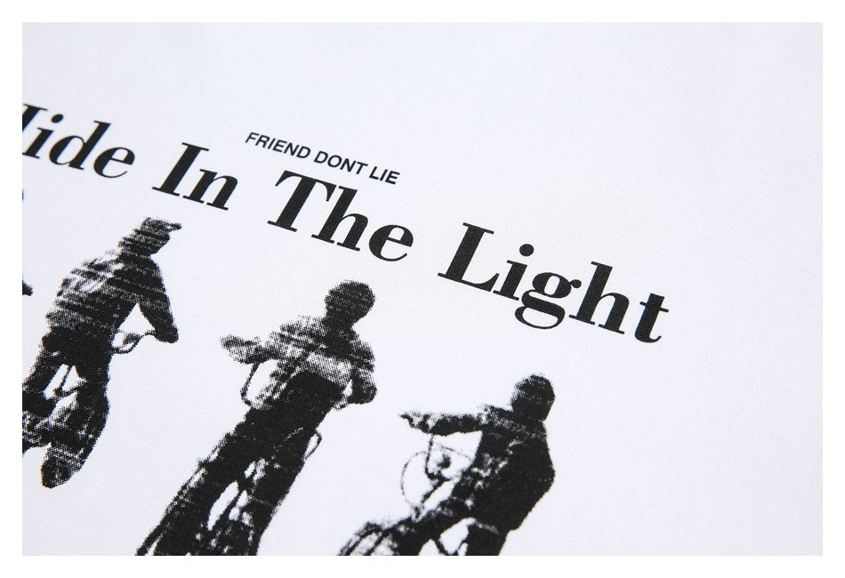 Close-up of a black motorcycle-rider graphic and English lettering printed on white fabric.