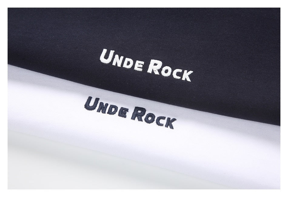 Close-up of black and white fabric with contrasting embroidered “Unde Rock” lettering.