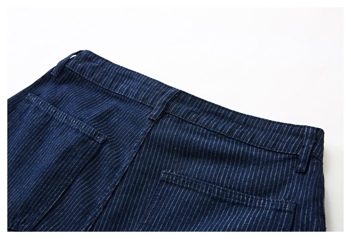 Close-up of the back waistband and pockets of dark navy pinstriped trousers.