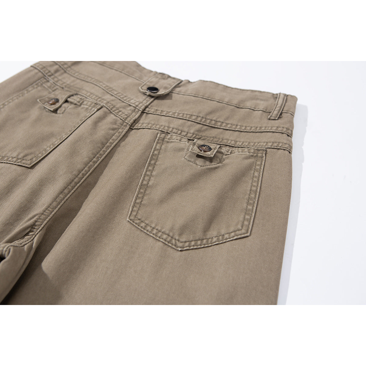 Close-up of taupe pants showing a buttoned back pocket, waistband, belt loops, and stitching.