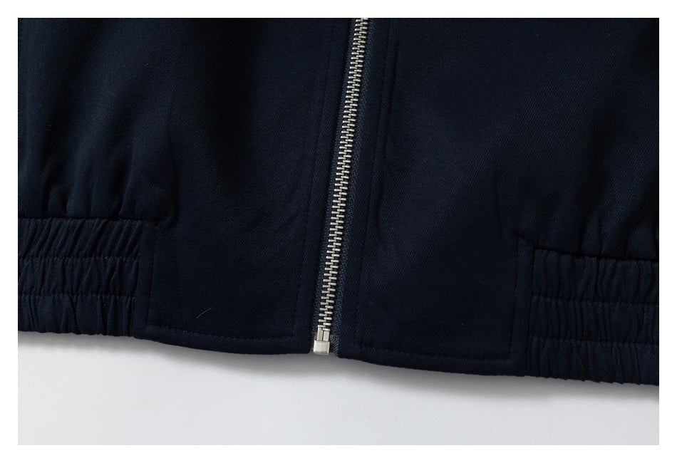 Close-up of the jacket's lower front, showing the center zipper and gathered elastic side hem sections.