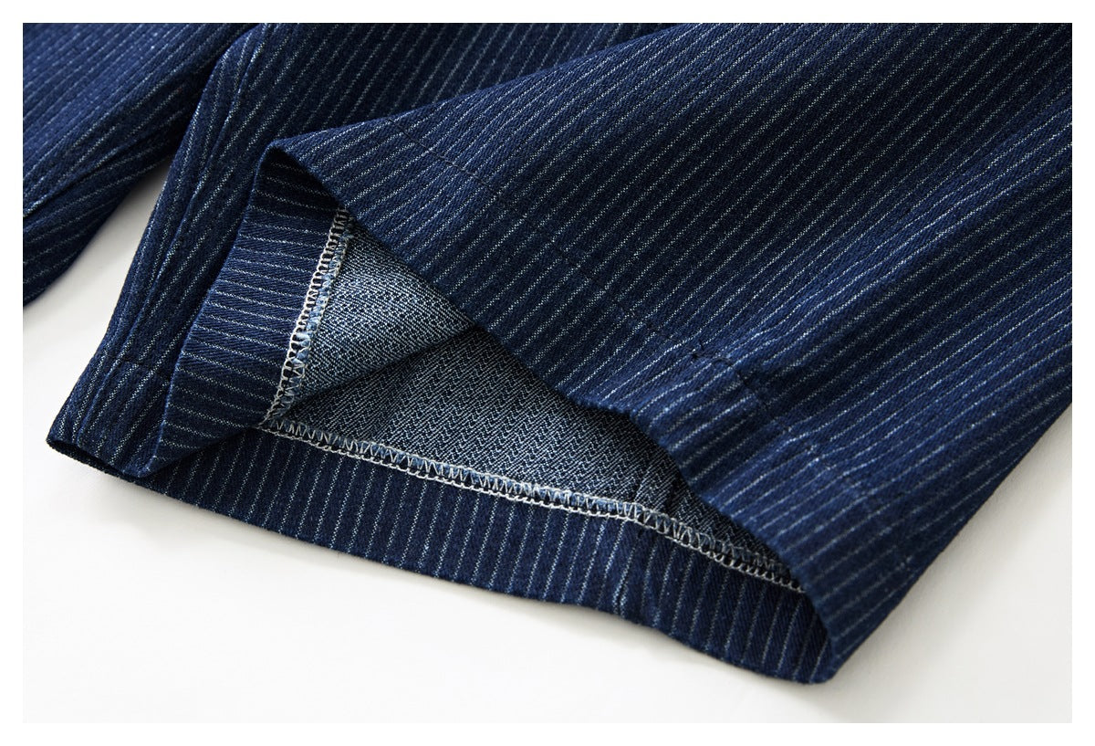 Close-up of a folded trouser hem showing the inner fabric and overlocked seam.