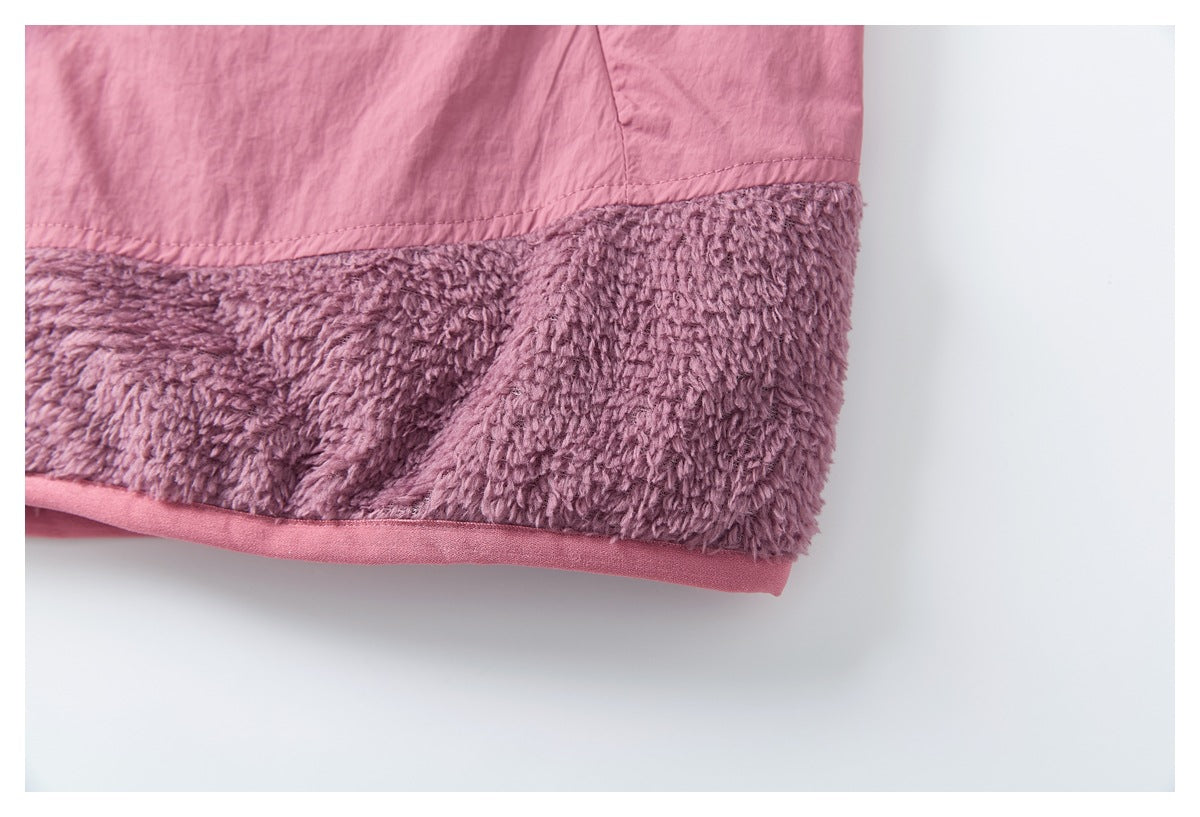 Close-up of the pink jacket hem with a wide mauve plush panel and pink binding.