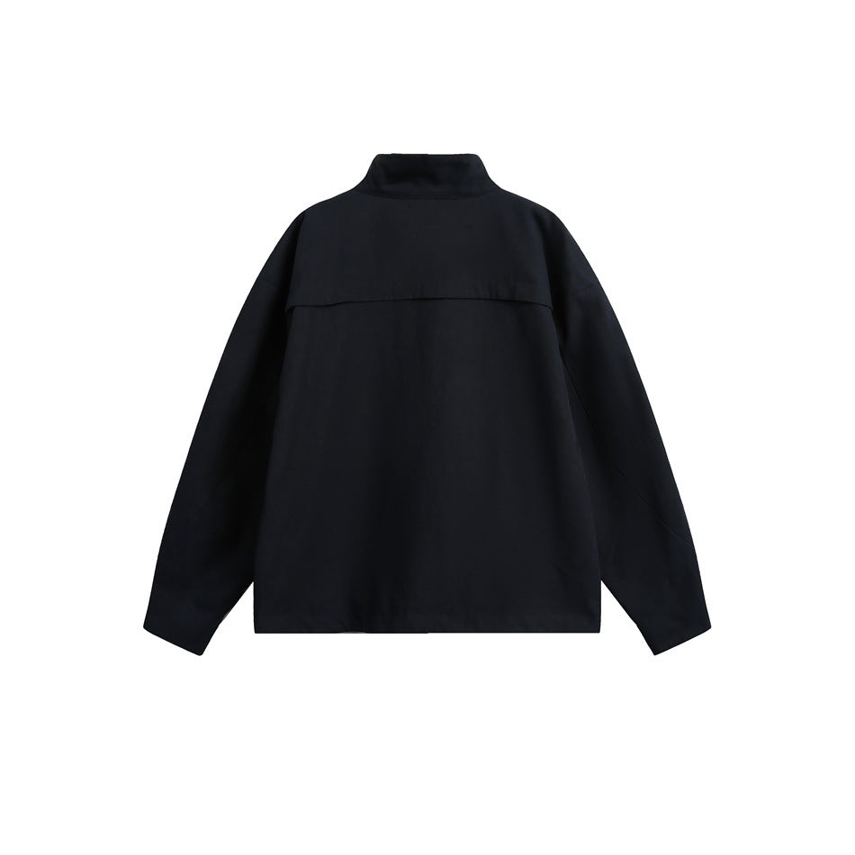 Back view of a black jacket with a stand collar, long sleeves, and a horizontal back yoke.