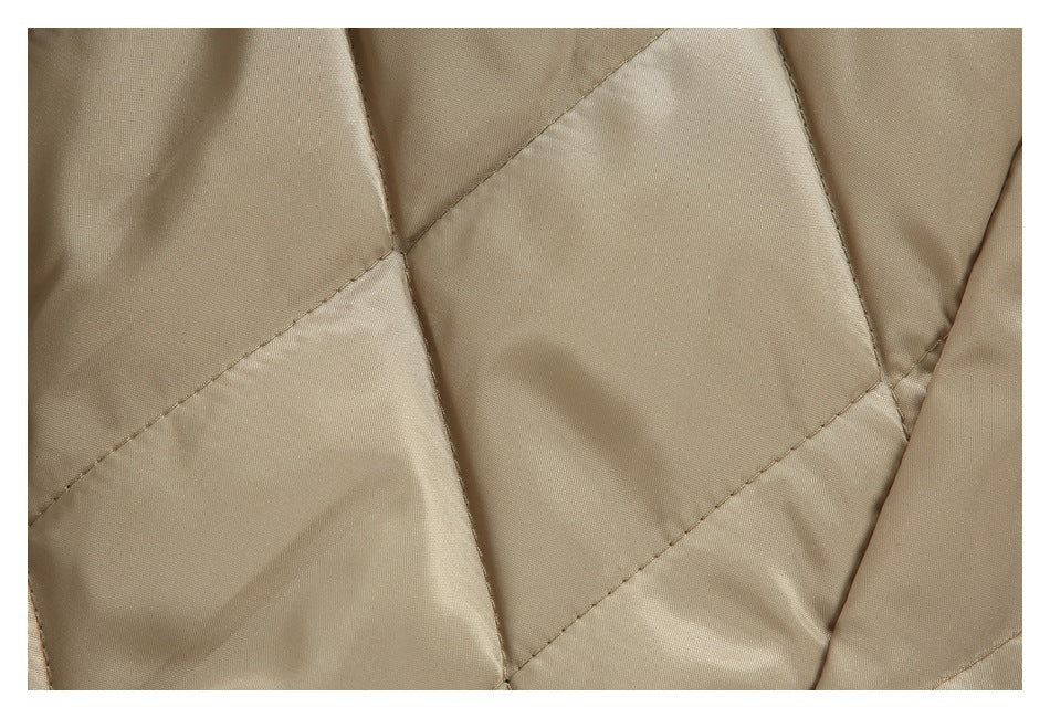 Close-up of beige quilted lining with diagonal stitched seams.