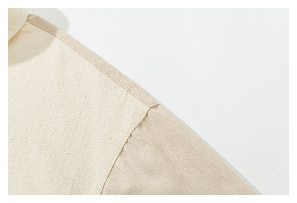 Close-up of an ivory shirt shoulder showing the seam and sleeve join.