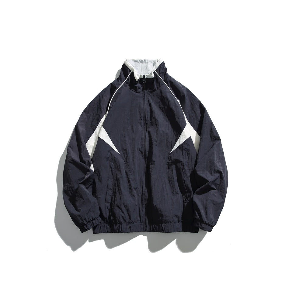 Navy track-style jacket with white contrast collar lining and white side panels, front zipper, elastic cuffs and hem