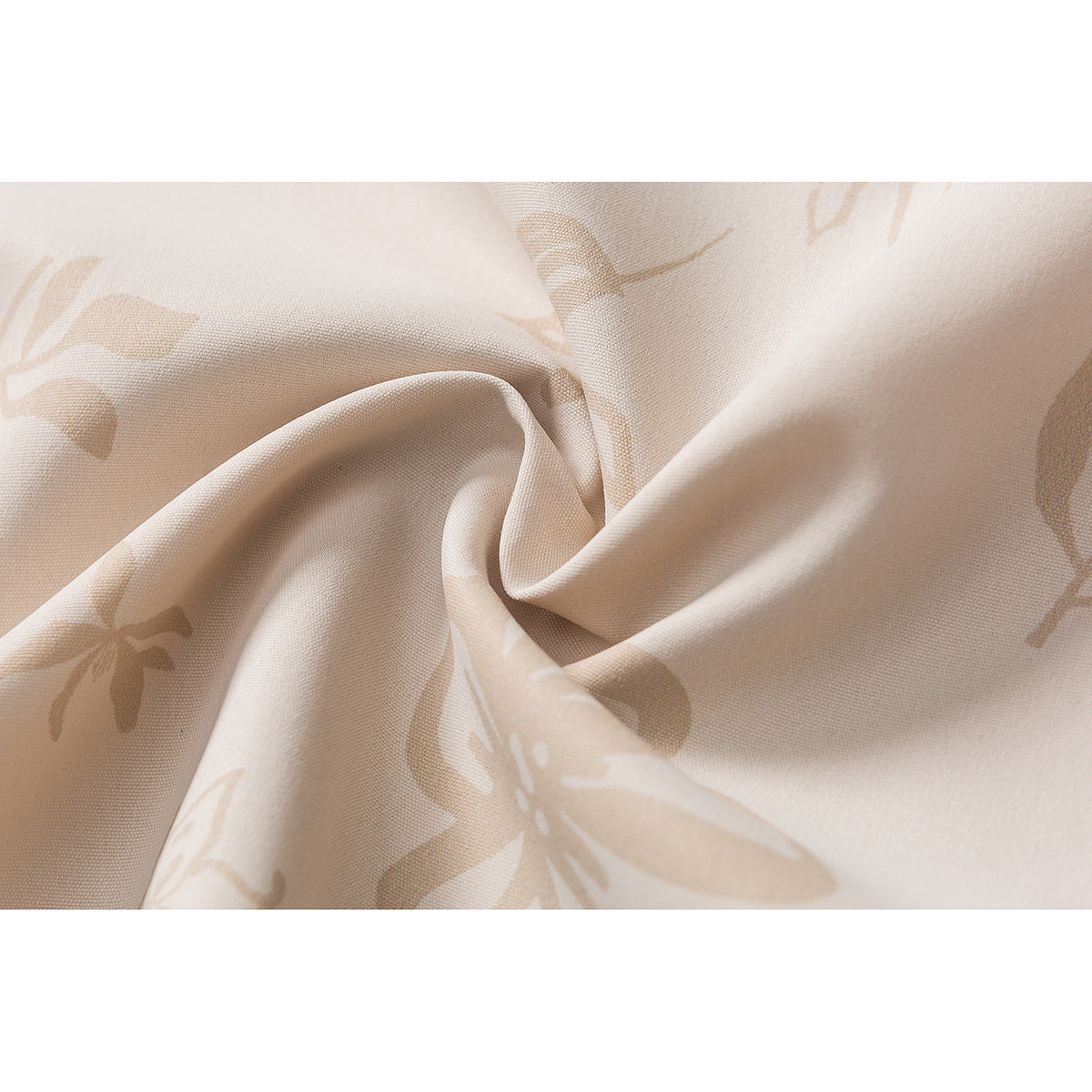 Close-up of beige fabric with a subtle floral print, gathered into soft folds.