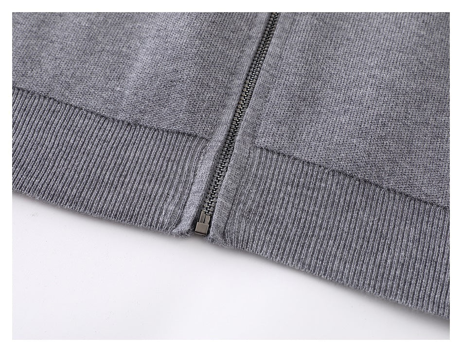 Close-up of the gray cardigan's ribbed hem and bottom of the front zipper.
