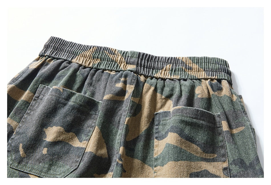 Upper back of camouflage shorts with an elastic waistband and two patch pockets.