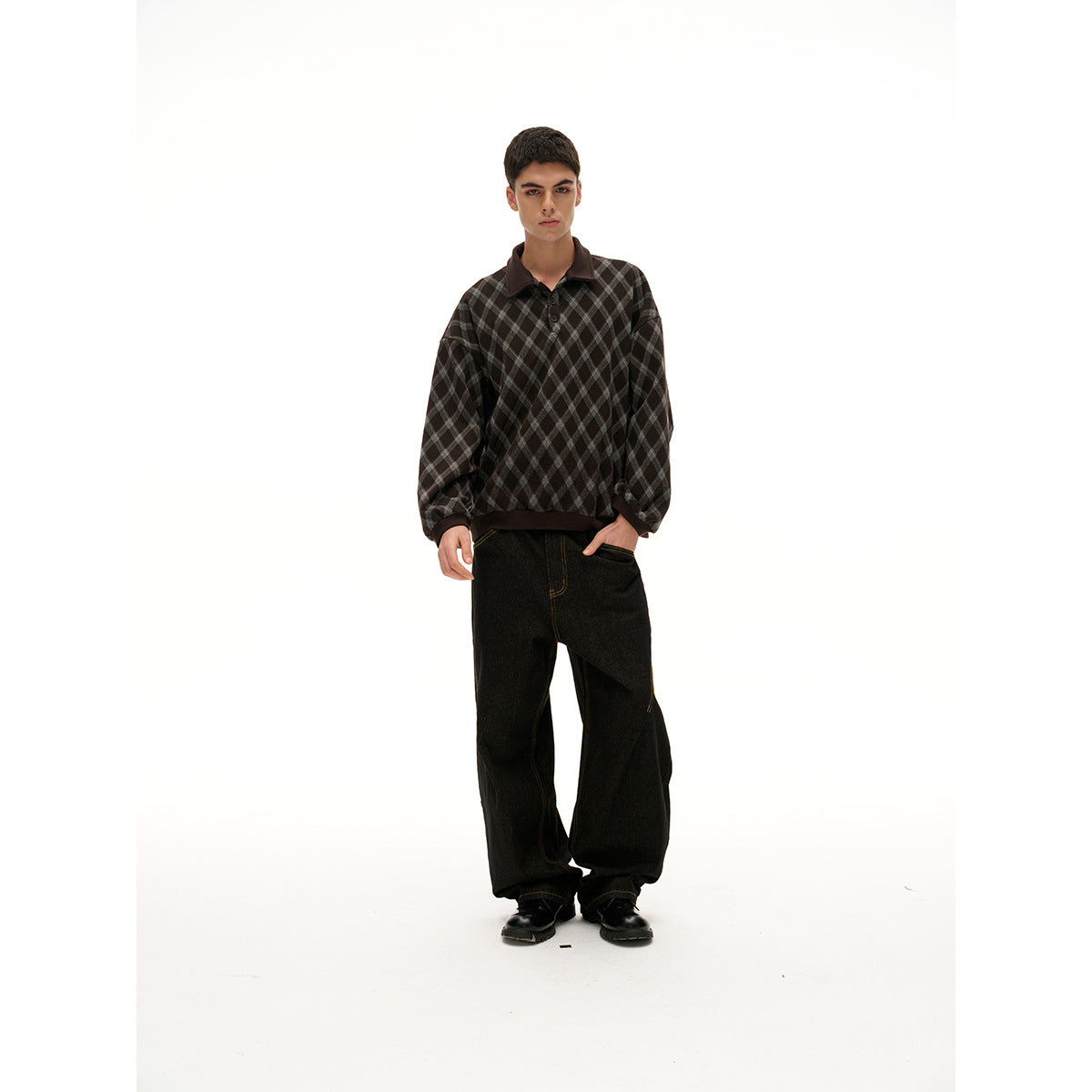 Model wearing a dark brown and gray diamond-check pullover with a collar and black wide-leg pants, front view.