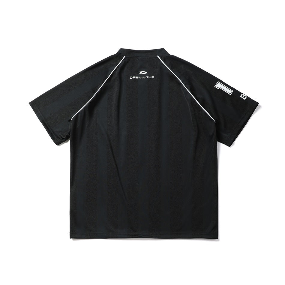 Back view of a black short-sleeve shirt with white piping, a small upper-back logo, and sleeve lettering.