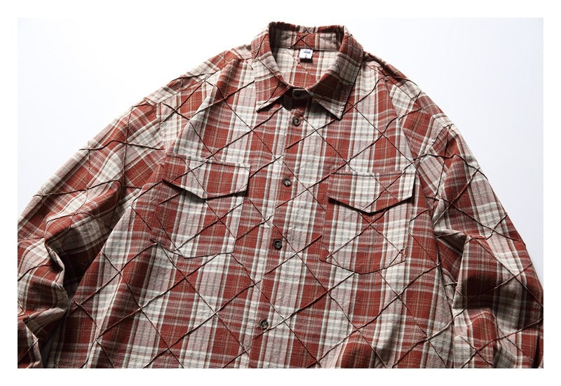 Front view of a rust red, cream, and gray plaid shirt with diamond stitching, button closure, and two flap chest pockets.
