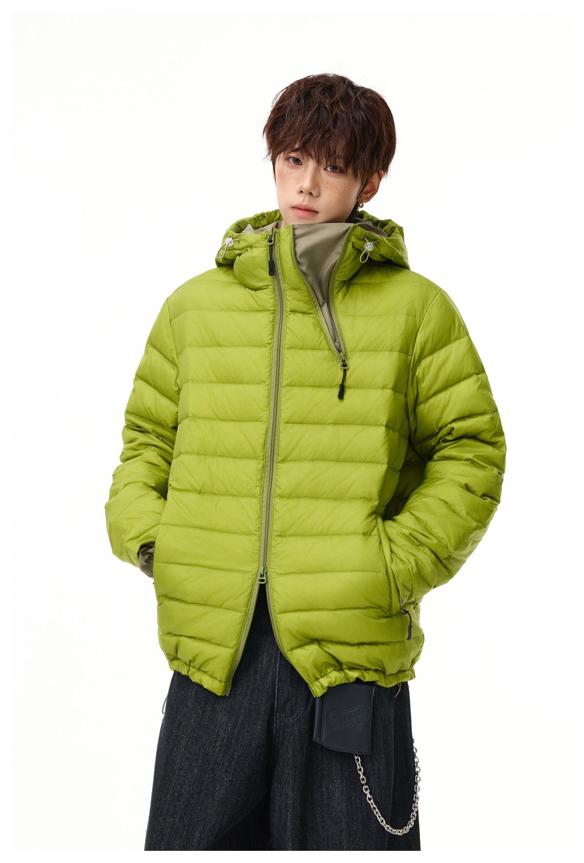 Front view of a lime-green hooded quilted jacket, partly unzipped to reveal its contrasting inner collar.