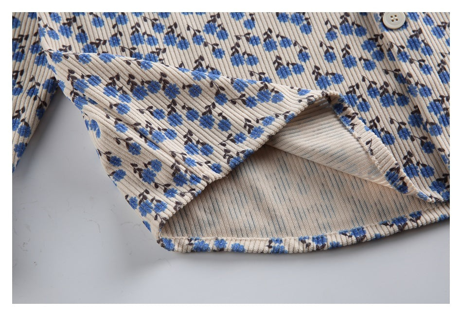 Close-up of the shirt's lower hem turned back to show the inside construction and ribbed floral fabric.