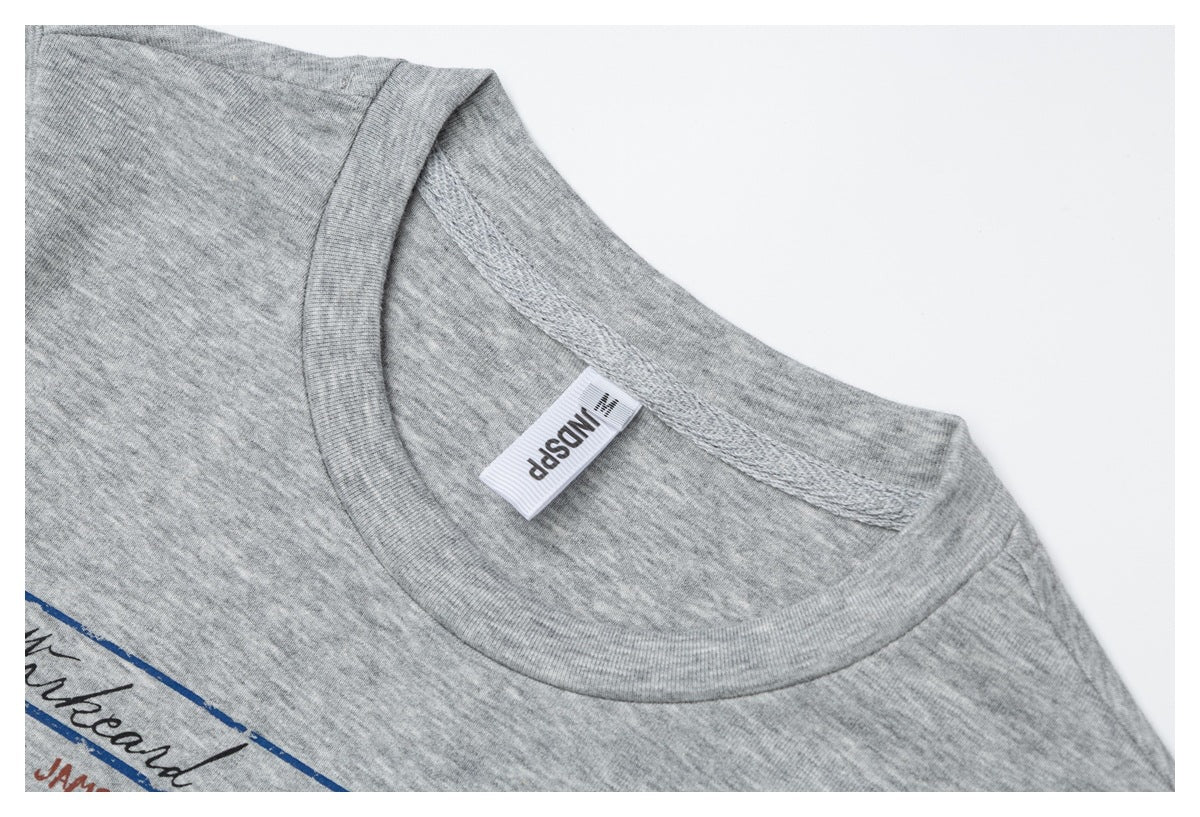 Close-up of a gray heather T-shirt crew neckline with ribbed trim and a sewn neck label.