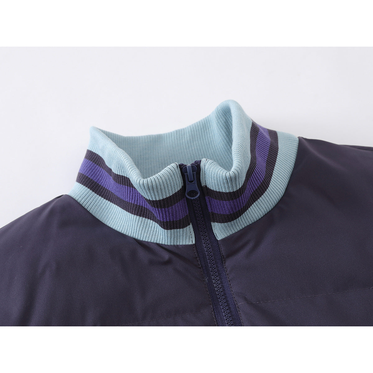 Close-up of a dark purple jacket's front zipper and light blue ribbed collar with purple and dark stripes.