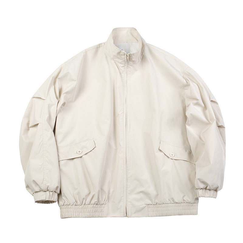 Beige stand-collar zip jacket with flap pockets and elastic cuffs, flat lay front view
