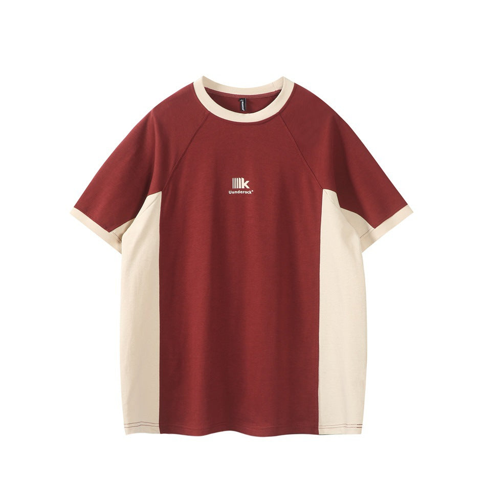 Rust red short-sleeve raglan T-shirt with beige collar, cuffs and side panels, flat front view with small chest print