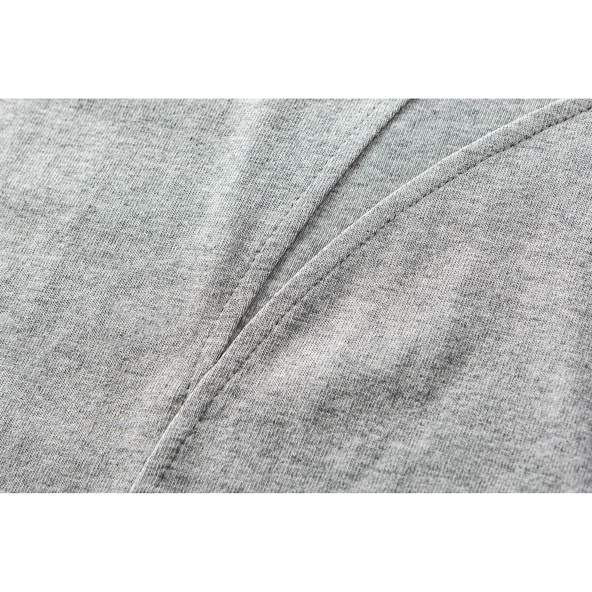 Close-up of the heather-gray T-shirt fabric and a curved stitched seam.