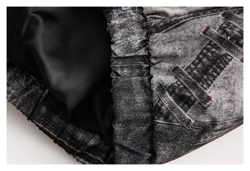 Close-up of the jacket's black lining and gathered seam against its black-and-gray patterned shell.