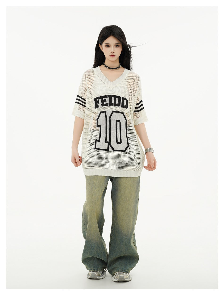 Model wearing an oversized ivory mesh-knit V-neck jersey with black sleeve stripes and FEIDD 10 lettering, paired with