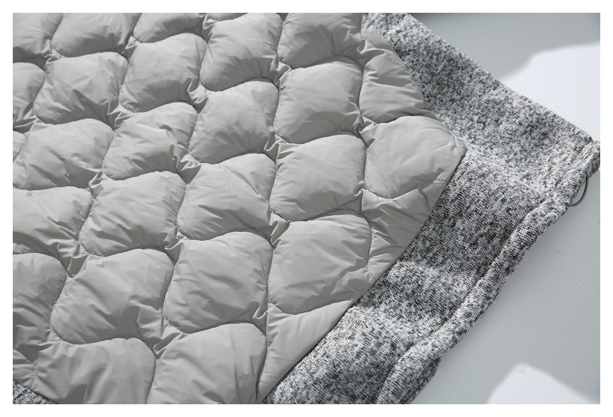 Close-up of the garment's light gray quilted lining beside its gray-and-black marled outer fabric.