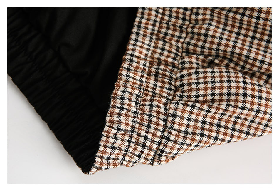 Close-up of houndstooth fabric beside a black gathered lining or panel.
