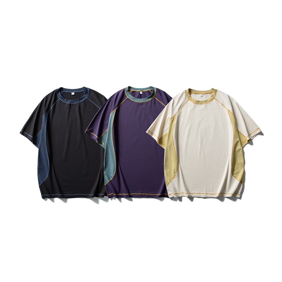 Three short-sleeve colorways shown together: black with blue-gray panels, purple with teal panels, and ivory with yellow