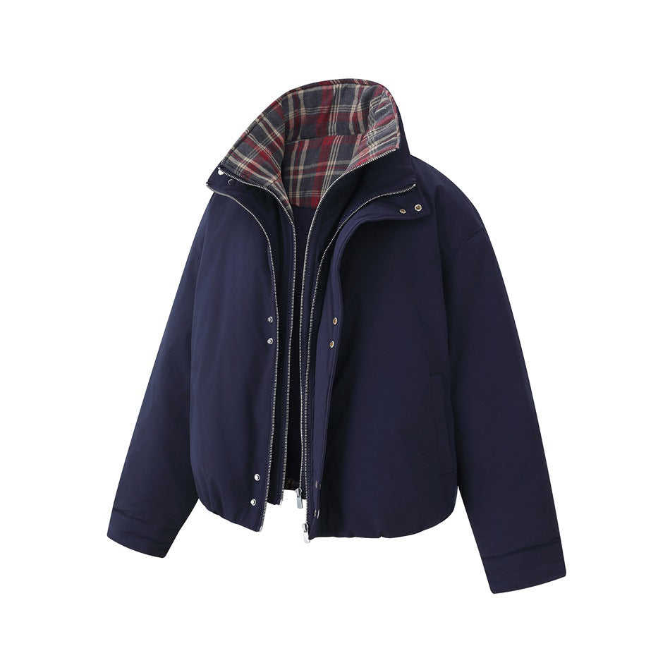 Front view of a navy jacket with its front open, revealing red, gray, and cream plaid lining inside the high collar.