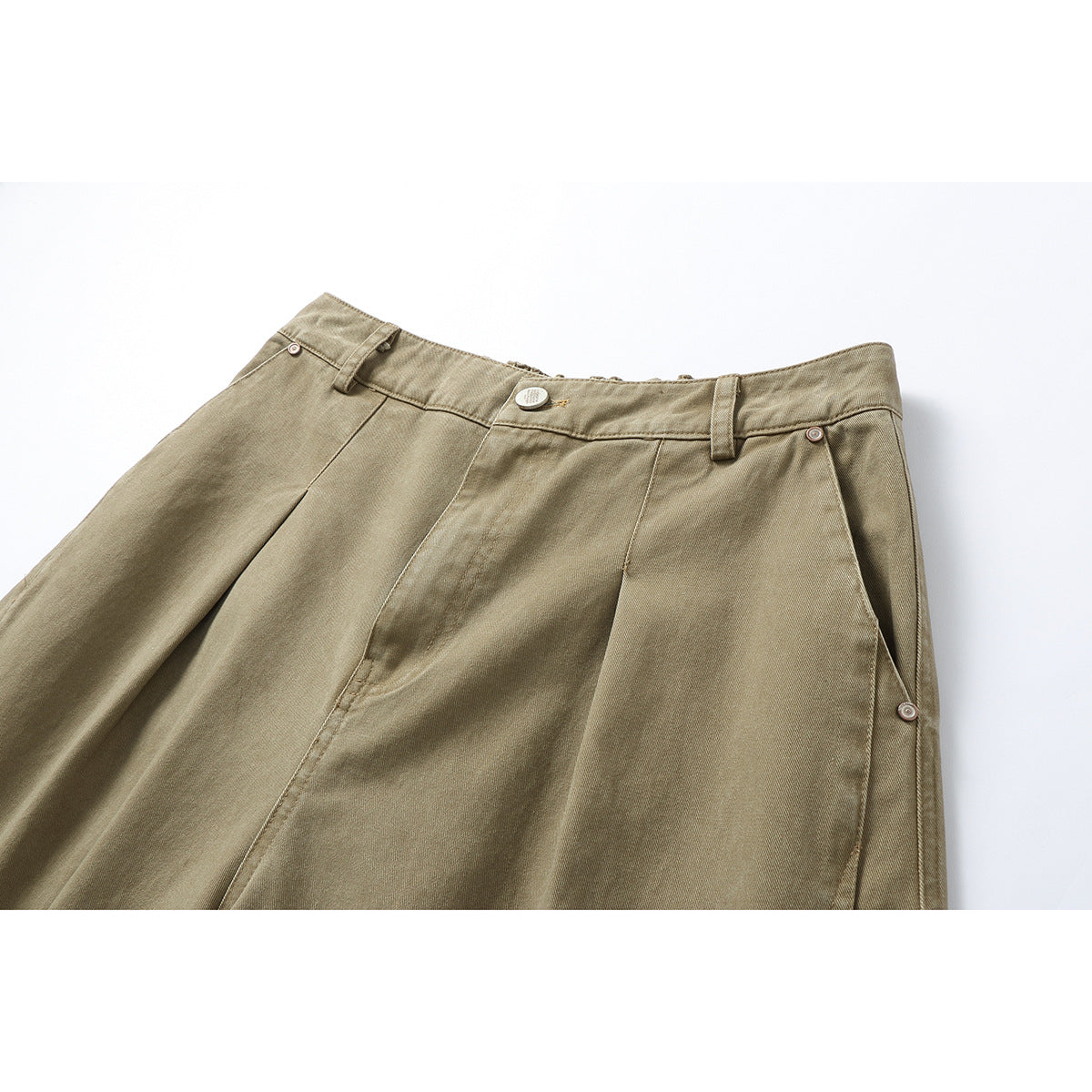 Close-up of tan pants waist with belt loops, front pleats and metal buttons along the side.