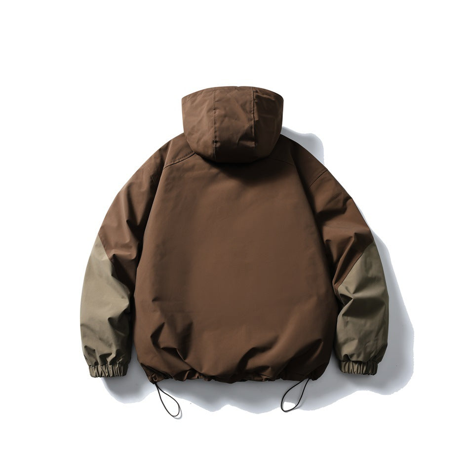 Back view of a brown hooded jacket with contrasting gray-green sleeves and an adjustable hem.