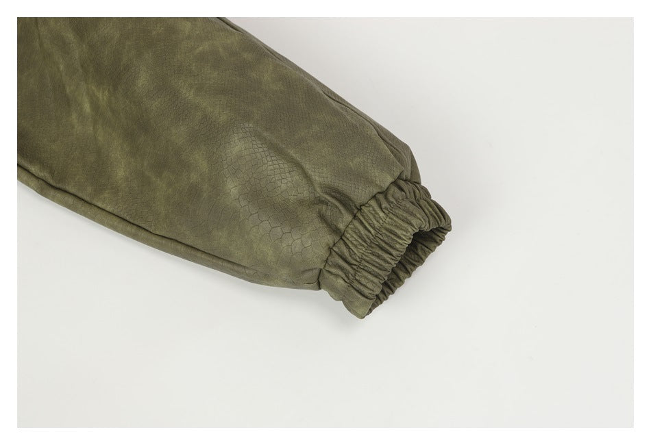 Close-up of an olive-green pant leg ending in a gathered elastic cuff.