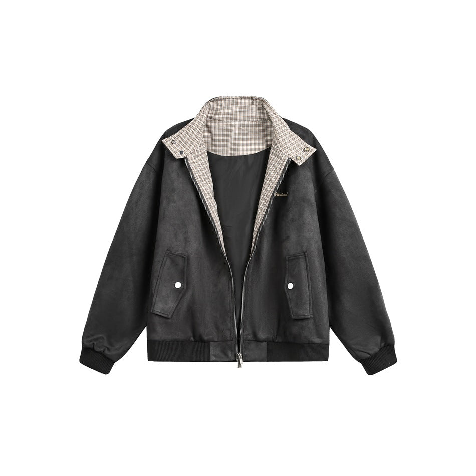 Black zip-front jacket with a beige plaid inner collar, snap-tab details, and two front pockets.
