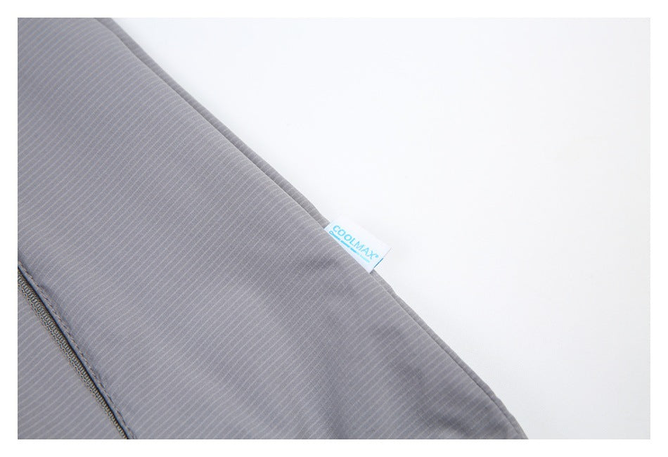 Close-up of gray finely striped garment fabric with a small COOLMAX tag.
