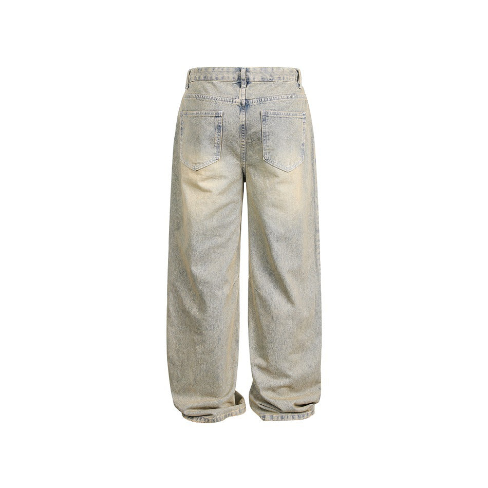 Back view of pale, faded blue-gray wide-leg jeans with two patch pockets and a center back seam.