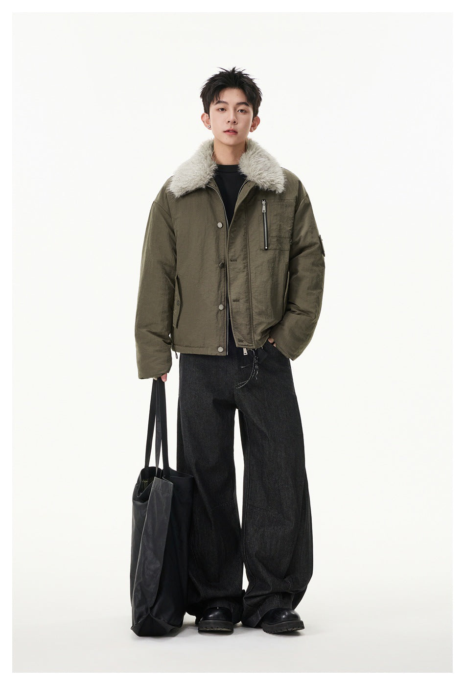 Full-length model wearing an olive jacket with a pale shaggy collar and wide black trousers.
