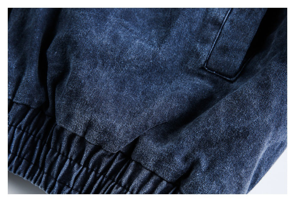 Close-up of the dark blue jacket's gathered elastic hem and adjacent fabric panels.