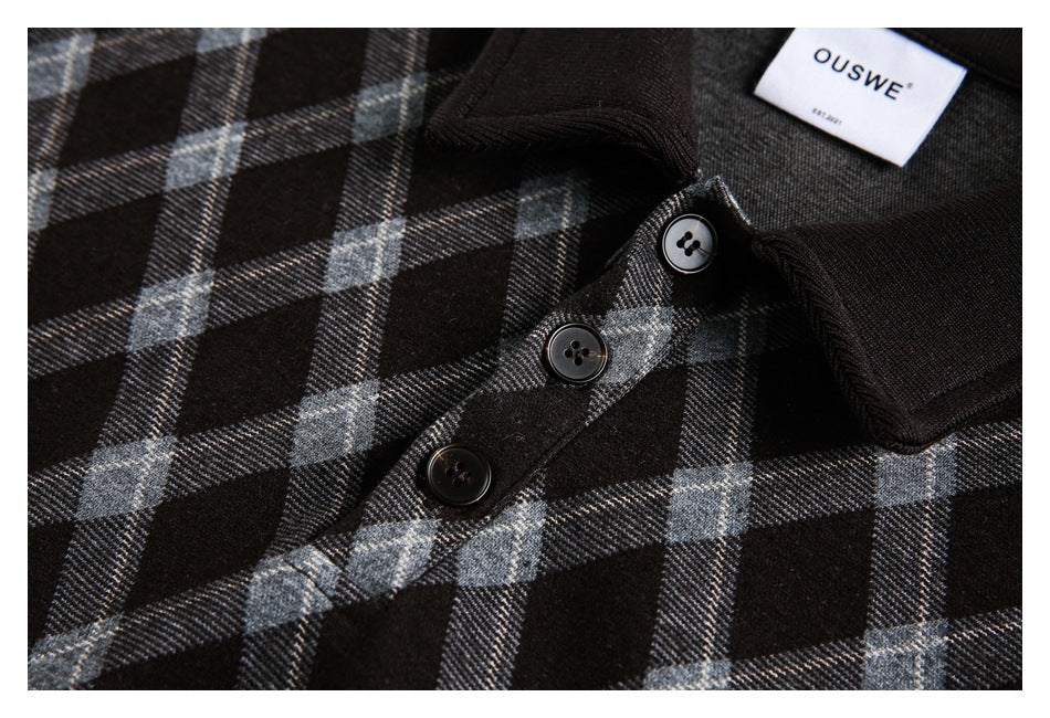 Close-up of a black plaid jacket's collar, three buttons, and sewn-in neck label.
