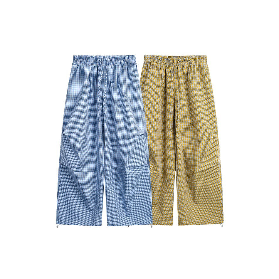 Two pairs of wide-leg check pants shown side by side in blue and yellow colorways.